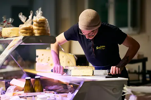 Man cuts a piece of cheese