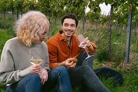 Couple drinking wine in the Vienna vineyards