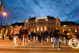 Museumsquartier by night with people passing by