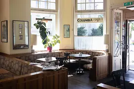 Interior of Café Rüdigerhof in Vienna with booth seating and large windows