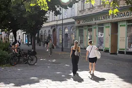 Two women strolling across Margaretenplatz in Vienna